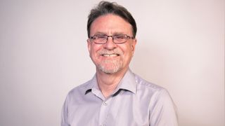 Smiling headshot of Academy Award winner Mike Perkins from Christie. 